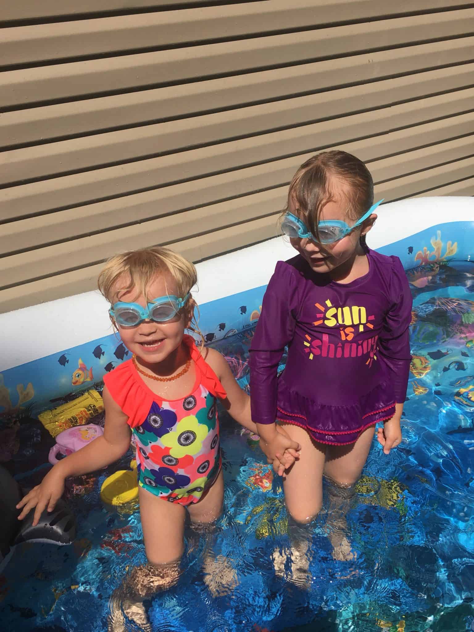 kids playing in kiddie pool wearing sunscreen