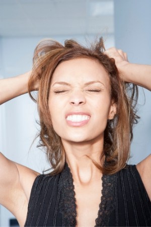 frustrated woman holding her hair
