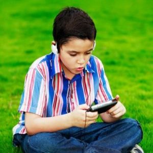boy playing a handheld gaming system