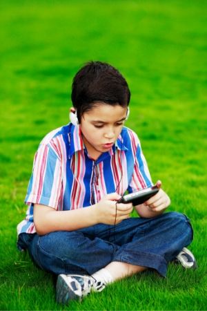 boy with handheld gaming system