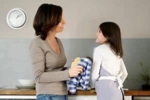 Respectful parenting mother with daughter doing chores