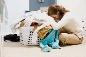 overwhelmed mom with laundry