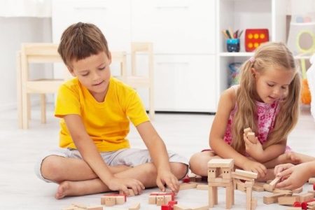 kids playing happily with wooden blocks