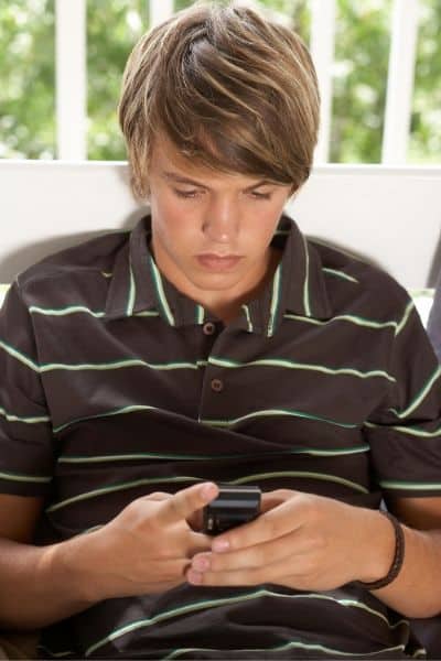 Teen-boy-avoiding-cyberbullying-on-cell-phone