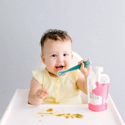 toddler eating serenity kids baby food with spoon
