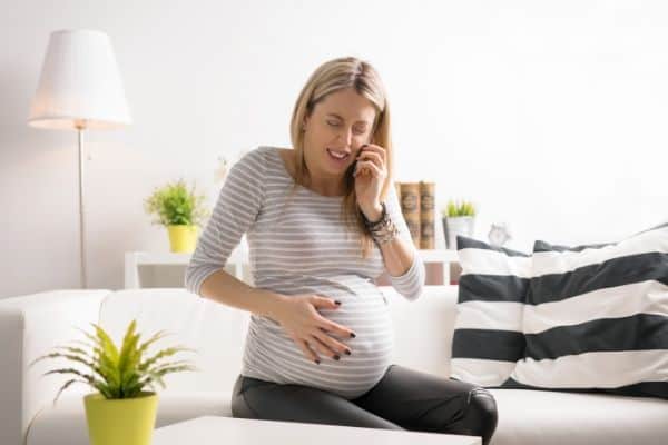 Woman on phone in painful contractions