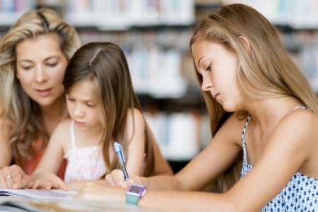 two homeschooling girls with mom