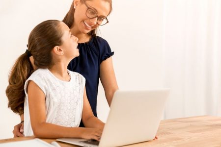 parent helping child with virtual learning