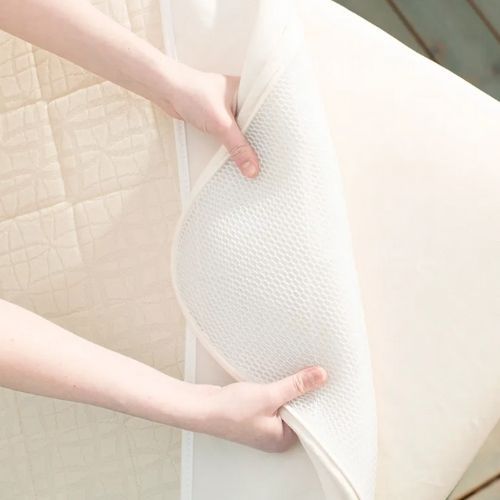 Honeycomb design in cotton cover makes the Ultra Breathable crib mattress from Naturepedic more breathable.