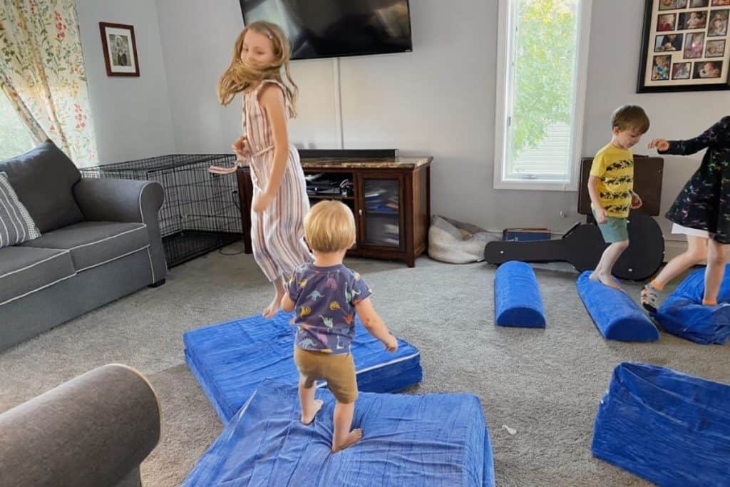 kids jumping on Brentwood home play couch pieces to help reshape them after unpacking