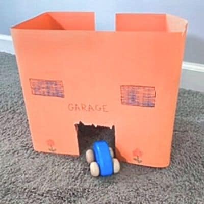 toy car garage made of cardboard box and construction paper