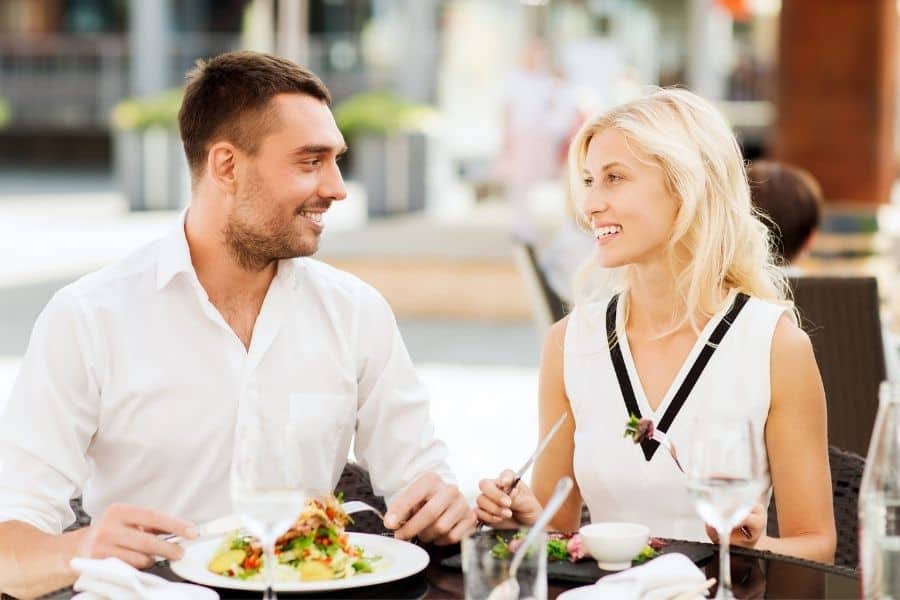 man and woman out at lunch before woman tells him she's pregnant