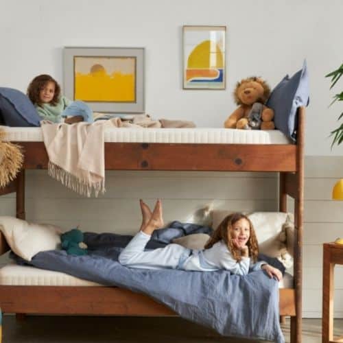 Two little girls, each in a bunk bed with the Avocado Eco Organic low profile mattresses