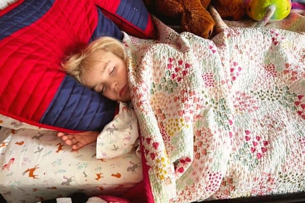 7 year old girl sleeping on the Juniper Kids memory foam mattress